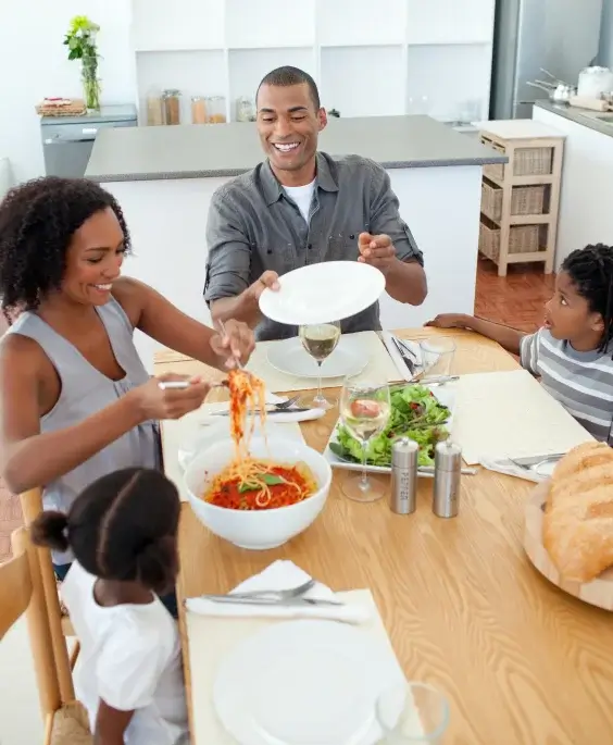 A family sitting at a table eating dinner in Lake Mills WI